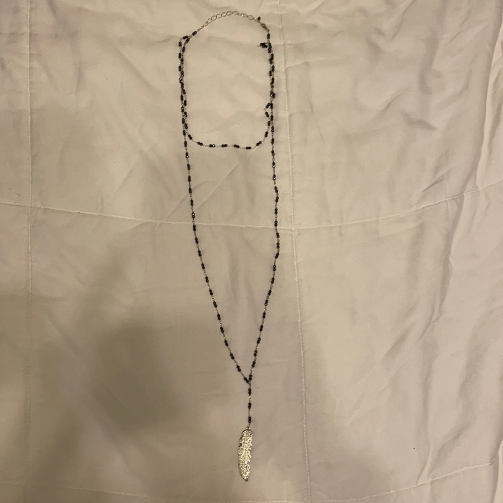 Long beaded necklace with feather pendant never worn